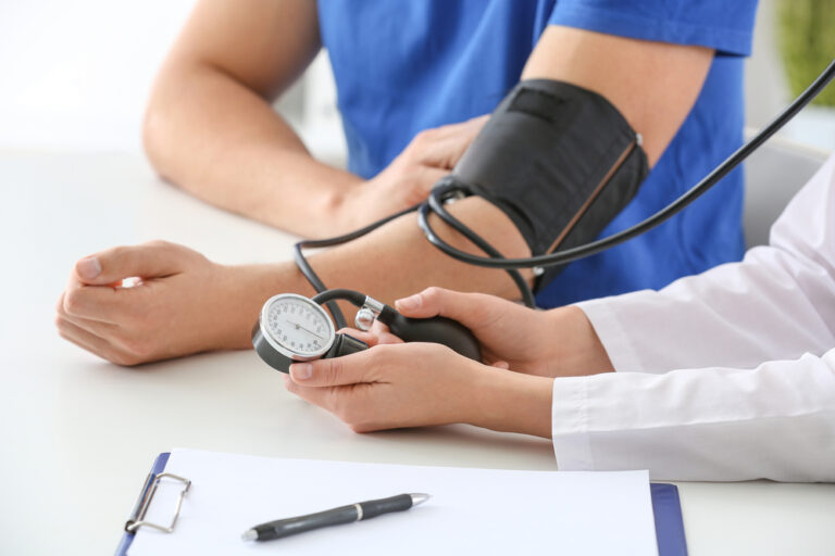 A photo of a person having their blood pressure checked as they suspect it may be low.