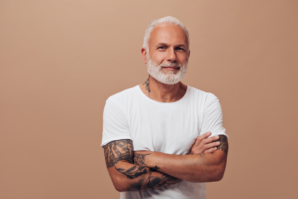 An older gentleman looks confident after taking supplements for his hair loss.