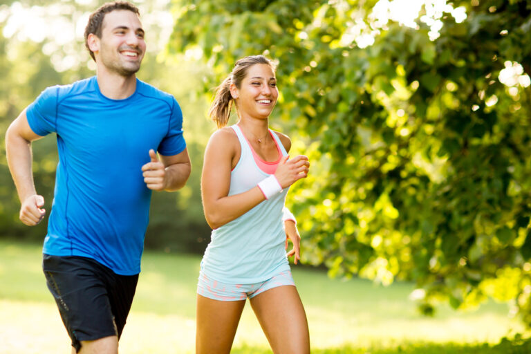 A younger couple running to increase their weight loss after taking Mounjaro to help kickstart their journey