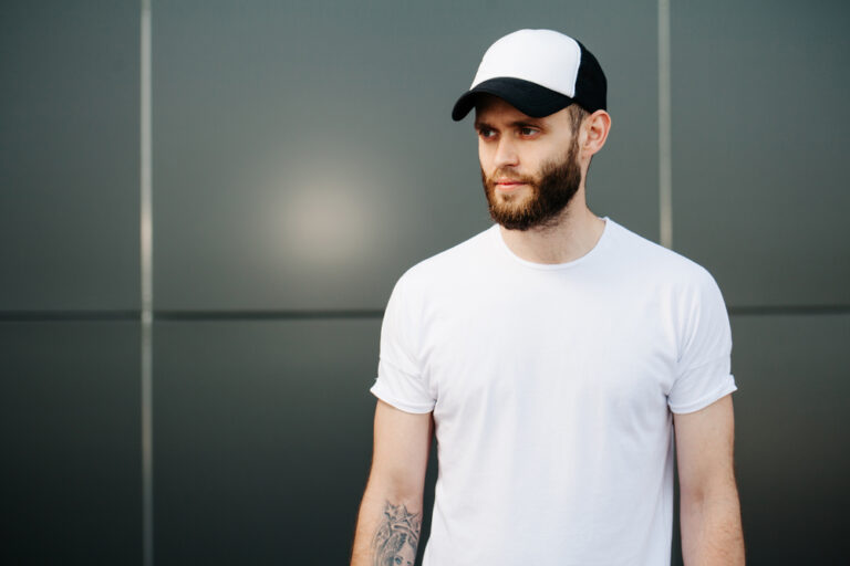 A man wears a baseball cap to cover his hair loss, caused by taking creatine.